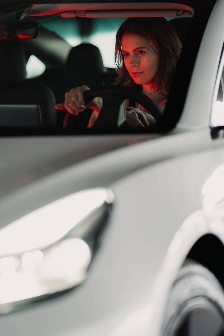 man in black jacket driving car