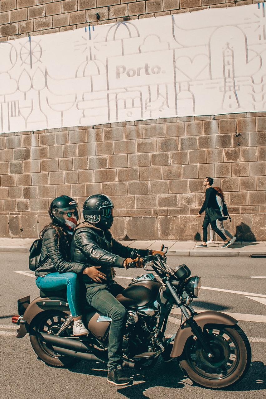 man in blue jacket riding on black motorcycle